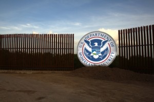 Image of Fence in with U.S. Department of Homeland Security shield in the middle. This is a symbol of the wall President Trump proposes to build to stop illegal immigration.