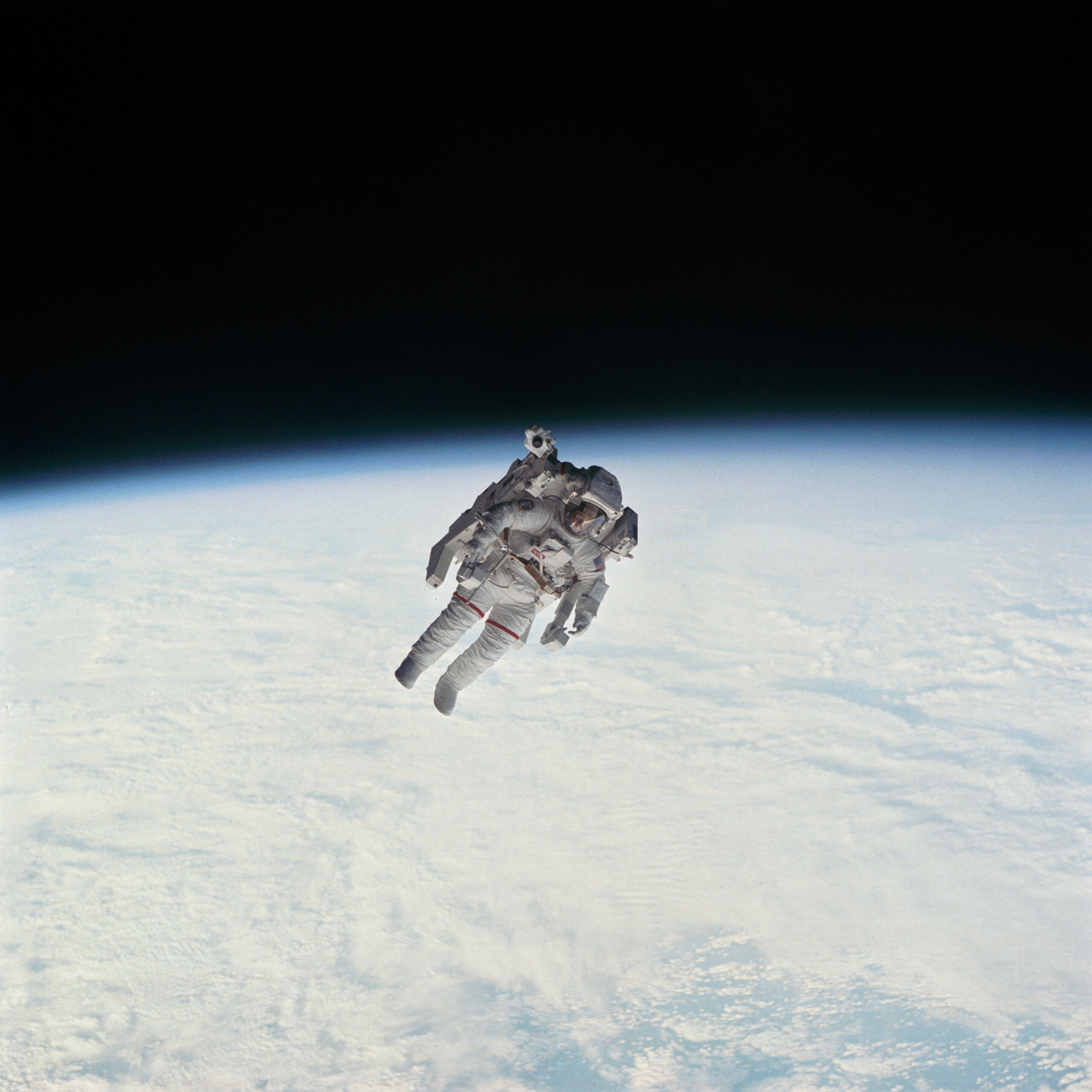 Astronaut floating above Earth’s horizon during a spacewalk