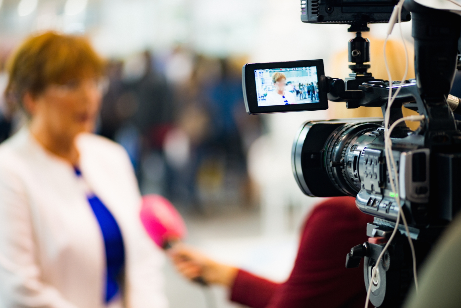 News cameras recording a media briefing