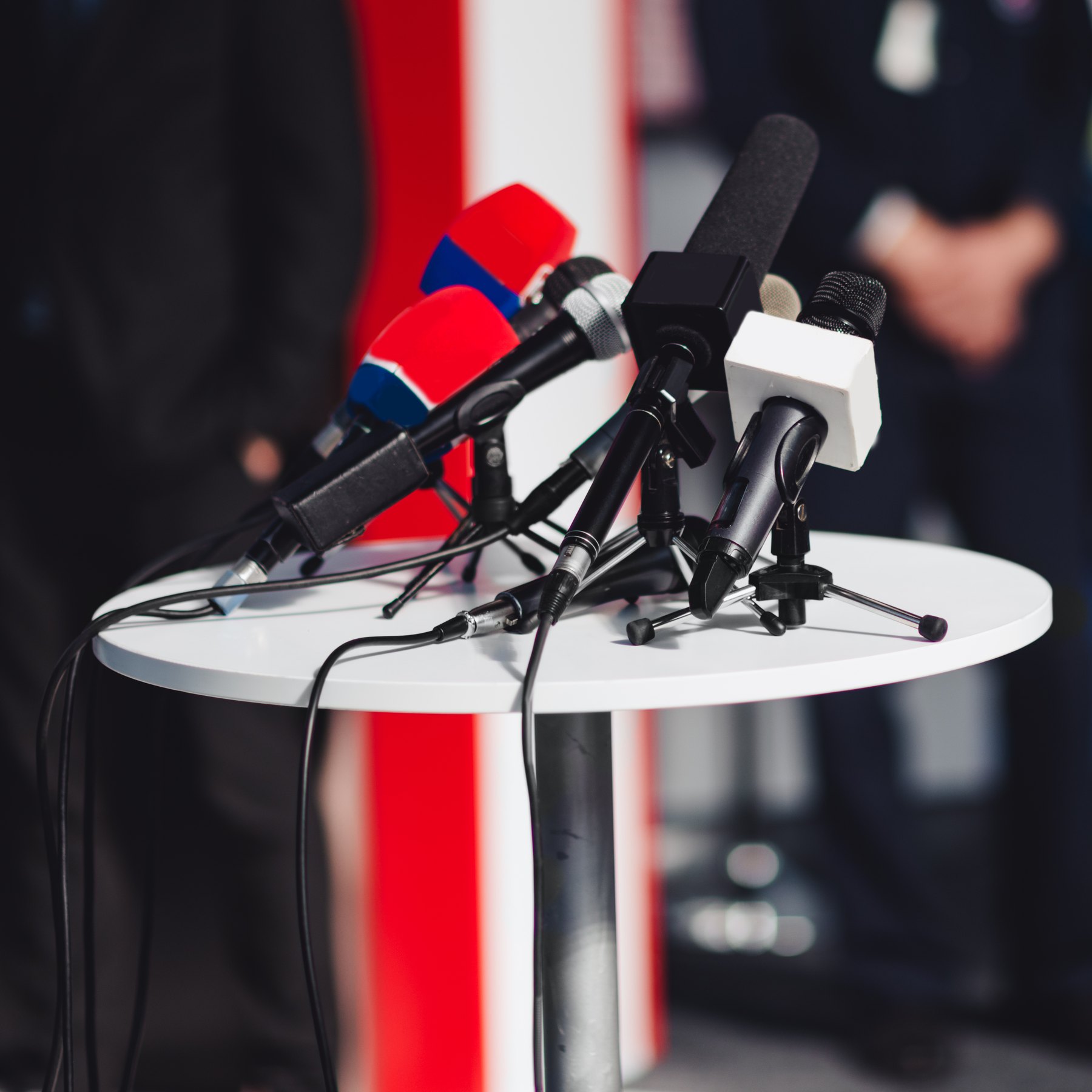 Microphones arranged on a table for a press conference.